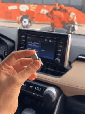 Wireless Car Play adapter by My Store, showing the compact device connected to a car's dashboard screen for seamless smartphone integration.